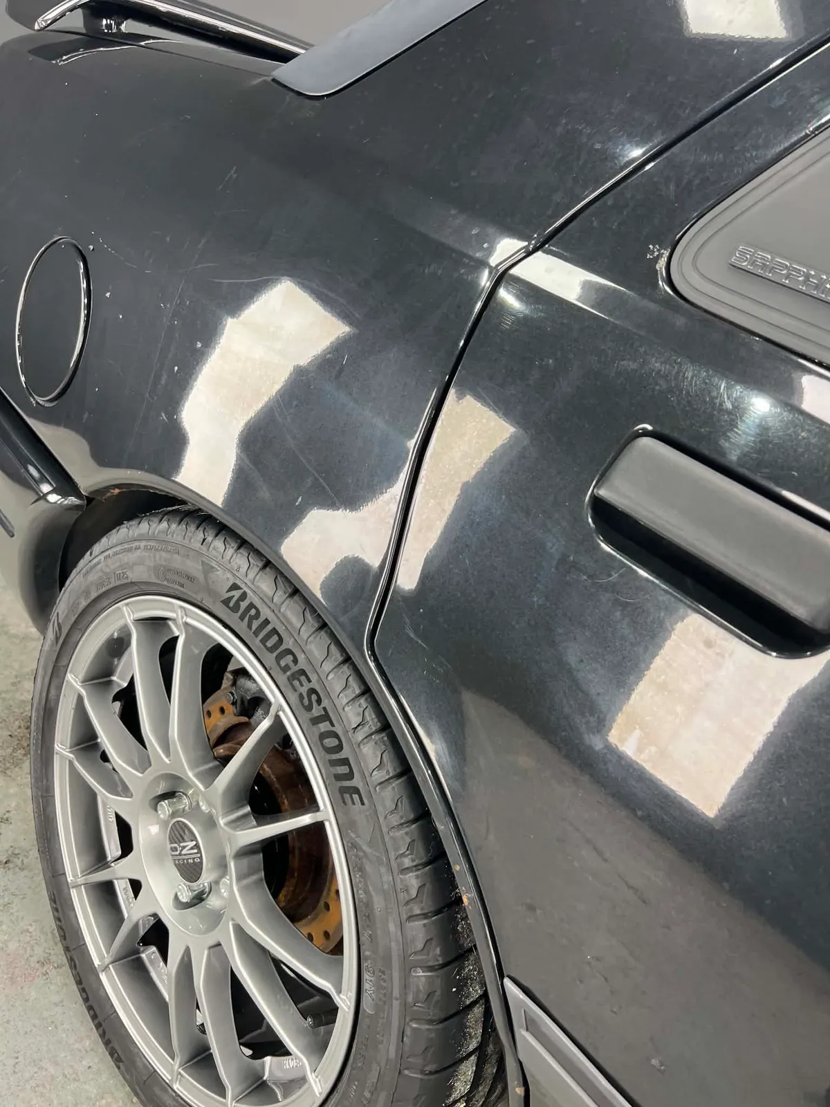 Close-up of detailed wheel arch and OZ Racing wheel